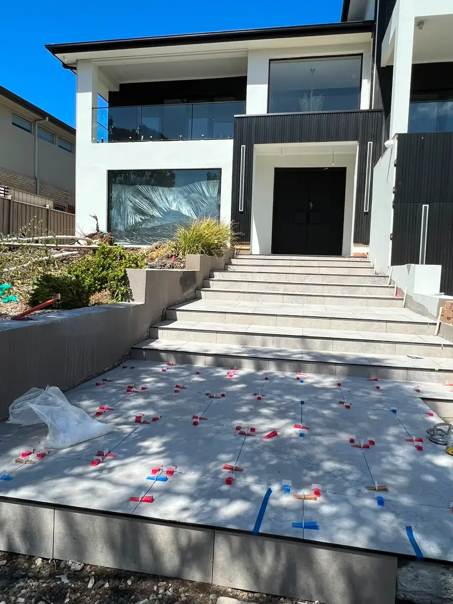 Front entry steps — after, large-format stone-look porcelain