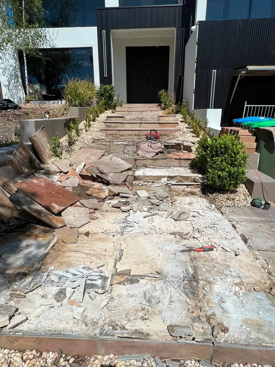 Front entry steps — before, old paving stripped back