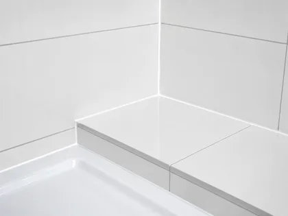 Close-up of a tiled shower seat corner with tight, level grout lines