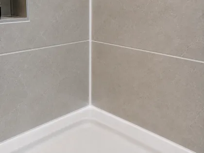 Close-up of a resealed shower corner joint
