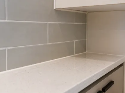 Close-up of splashback tile edge against benchtop
