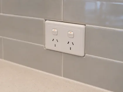 Close-up of tile cut cleanly around a power point